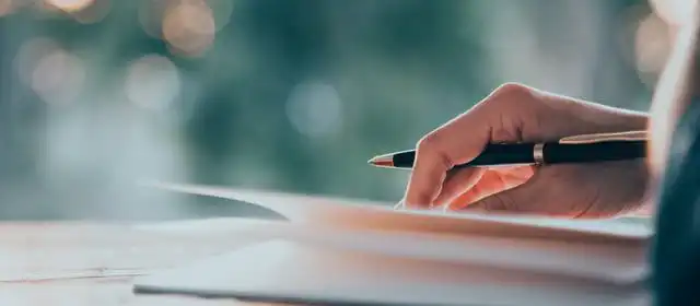 Close up women hand on writing on notebook and work with smart phone